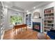 Bright home office with custom built-in bookshelves and a cozy fireplace at 1564 S Uinta Way, Denver, CO 80231