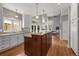 Spacious kitchen with a large central island, white cabinets, and access to an outdoor patio at 1564 S Uinta Way, Denver, CO 80231