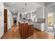 Well-lit kitchen featuring a central island, custom cabinetry, and modern appliances at 1564 S Uinta Way, Denver, CO 80231