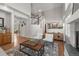 Open-concept living room with a fireplace and access to the dining and kitchen areas at 1564 S Uinta Way, Denver, CO 80231