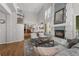 Spacious living room with a modern fireplace, high ceilings, and hardwood floors at 1564 S Uinta Way, Denver, CO 80231