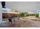 Brick patio with shade sail, outdoor seating, and a wooden fence for privacy at 1736 Grove St, Denver, CO 80204