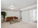Inviting basement space featuring plush seating, a sleek glass coffee table, and ample room at 1736 Grove St, Denver, CO 80204