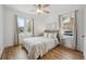 Bright bedroom with neutral decor, hardwood floors, and natural light from two windows at 1736 Grove St, Denver, CO 80204
