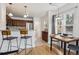 Bright dining area with breakfast bar, hardwood floors, and view to stainless steel appliances at 1736 Grove St, Denver, CO 80204