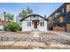 Charming home featuring a bright red door and beautiful rock landscaping for added curb appeal at 1736 Grove St, Denver, CO 80204