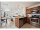 Stylish kitchen with stainless steel appliances and wood cabinets opens to the living room at 1736 Grove St, Denver, CO 80204