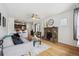 Open living space with hardwood floors, stone fireplace, and view into adjacent kitchen at 1736 Grove St, Denver, CO 80204