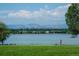 Scenic view of Sloan's Lake with mountains in the background and a walking path at 1736 Grove St, Denver, CO 80204
