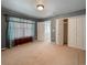 Carpeted bedroom with window and double doors to closet at 11275 Columbine St, Firestone, CO 80504