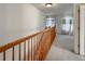 Upstairs hallway with wood railing and carpet at 11275 Columbine St, Firestone, CO 80504