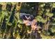 Drone view of large house showing the roof, surrounding trees, and long driveway at 2873 Cortina Ln, Evergreen, CO 80439