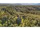 Aerial view of residence in wooded area, showcasing its private and serene natural setting at 2873 Cortina Ln, Evergreen, CO 80439