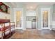 Spacious basement area with a small bar, decorative glass doors, and slate tile flooring at 2873 Cortina Ln, Evergreen, CO 80439