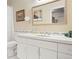Bathroom features a vanity with white cabinets, a white countertop, and a framed mirror at 2873 Cortina Ln, Evergreen, CO 80439