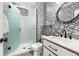 Chic bathroom featuring modern fixtures, decorative wallpaper, and a glass-enclosed shower at 2873 Cortina Ln, Evergreen, CO 80439