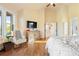 Bedroom features a decorative dresser and large window with great natural light and a comfortable chair at 2873 Cortina Ln, Evergreen, CO 80439