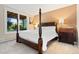 Inviting bedroom with warm colors and a large window with a view of the trees outside at 2873 Cortina Ln, Evergreen, CO 80439