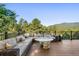 Expansive outdoor deck with comfortable seating arrangement, perfect for entertaining and enjoying mountain views at 2873 Cortina Ln, Evergreen, CO 80439