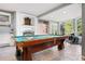 Large game room featuring a billiard table, wet bar, drum set, and views of nature at 2873 Cortina Ln, Evergreen, CO 80439
