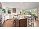 Spacious kitchen with stainless steel island, modern appliances, and large windows overlooking outdoor space at 2873 Cortina Ln, Evergreen, CO 80439