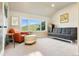 Relaxing living room with mountain views, featuring a comfortable leather chair, ottoman, and sofa with clean modern lines at 2873 Cortina Ln, Evergreen, CO 80439