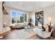 Bright living room with modern decor, large windows offering scenic views, and comfortable seating at 2873 Cortina Ln, Evergreen, CO 80439