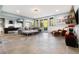 Spacious living room with stone tile floors, a large gray sofa, and natural light from many large windows at 2873 Cortina Ln, Evergreen, CO 80439