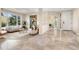 Spacious living room with large windows, tile flooring, and stylish décor; perfect for entertaining at 2873 Cortina Ln, Evergreen, CO 80439