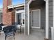 Townhouse entryway with gray door and black patio furniture at 9051 Bear Mountain Dr, Highlands Ranch, CO 80126