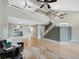 Living room with hardwood floors, loft, and view of kitchen at 9051 Bear Mountain Dr, Highlands Ranch, CO 80126