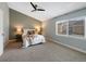 Main bedroom with large window and carpeted floor at 9051 Bear Mountain Dr, Highlands Ranch, CO 80126