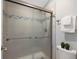 Clean shower with tiled walls and glass enclosure at 9051 Bear Mountain Dr, Highlands Ranch, CO 80126