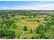 Expansive aerial view of the neighborhood showcasing lush green spaces, mature trees, and walking paths at 13246 Deneb Dr, Lone Tree, CO 80124