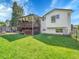 Large grassy backyard with a covered deck, perfect for relaxing or entertaining at 13246 Deneb Dr, Lone Tree, CO 80124
