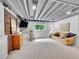 Finished basement features painted ceiling, carpet floors, a couch, and a tv at 13246 Deneb Dr, Lone Tree, CO 80124