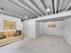 Finished basement features painted ceiling, carpet floors, and a leather couch at 13246 Deneb Dr, Lone Tree, CO 80124