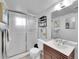 Modern bathroom featuring a shower, sink, and a sleek wooden cabinet at 13246 Deneb Dr, Lone Tree, CO 80124