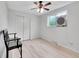 Simple bedroom with wood floors, a window air conditioner, and a black bench at 13246 Deneb Dr, Lone Tree, CO 80124