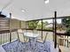 This covered wooden deck has outdoor seating and great views of the surrounding landscaping at 13246 Deneb Dr, Lone Tree, CO 80124