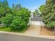 Charming front yard with a large shade tree and a multi-car driveway at 13246 Deneb Dr, Lone Tree, CO 80124