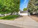 Charming two-story home features a well-maintained lawn, mature trees, and a two-car garage at 13246 Deneb Dr, Lone Tree, CO 80124