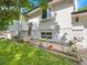 Charming white home featuring manicured garden beds and a lush green lawn at 13246 Deneb Dr, Lone Tree, CO 80124