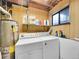Utility room with washer, dryer, hot water tank and storage shelf at 13246 Deneb Dr, Lone Tree, CO 80124