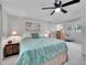 Well-lit main bedroom with ceiling fan, carpet floors, and a large bed at 13246 Deneb Dr, Lone Tree, CO 80124