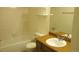 Tiled bathroom with a tub/shower combination, toilet, and single sink vanity at 14806 E 2Nd Ave Ave # 105G, Aurora, CO 80011