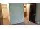 Carpeted bedroom with neutral walls, closet, and views to the kitchen at 14806 E 2Nd Ave Ave # 105G, Aurora, CO 80011