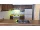 Functional kitchen with a range, refrigerator, and double basin sink at 14806 E 2Nd Ave Ave # 105G, Aurora, CO 80011