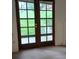 Bright living room featuring large glass doors offering view to the yard at 14806 E 2Nd Ave Ave # 105G, Aurora, CO 80011
