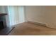 Bright living room featuring a cozy brick fireplace and sliding glass doors to the outside at 14806 E 2Nd Ave Ave # 105G, Aurora, CO 80011